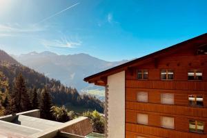 a wooden building with a view of the mountains at Mondzeu C261 in Bagnes