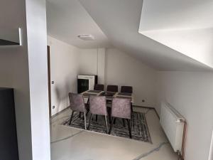 a dining room with a table and chairs at Apartman No1 in Cetingrad +1 photo