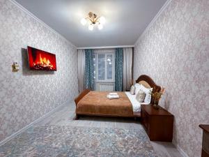 Ένα ή περισσότερα κρεβάτια σε δωμάτιο στο Уютная квартира для 6-х в 10 мин от Mega Park