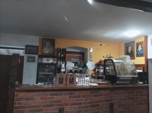 a counter in a room with a brick wall at Hostinec U Koláče in Jablonné v Podještědí