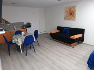 a living room with a table and a couch at Jolsva in Rokiškis