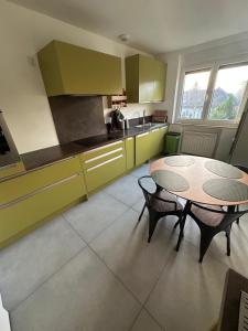 kuchnia ze stołem i krzesłami w obiekcie Vaste appartement avec parking gratuit, borne dispo et espace de travail w mieście Illkirch-Graffenstaden