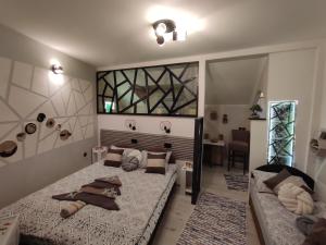 a bedroom with a large bed and a desk at Samy in Sarajevo