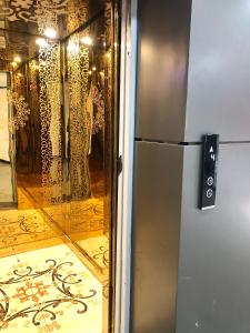 a refrigerator in a room with a glass door at Lavish 1BHK Apartment in Rawalpindi