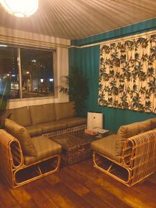 a living room with a couch and two chairs at Riverside HOSTEL CHILLAX Namba in Osaka +62 photos