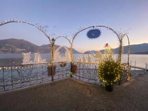 a gate with a christmas tree and lights at Nobiallum B&B in Menaggio