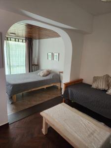 a bedroom with two beds and a window at Costa de Tigre, habitaciones in Tigre