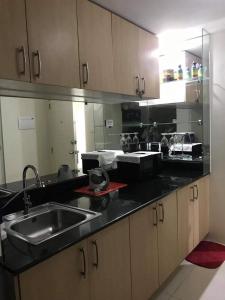 a kitchen with a sink and a counter top at Smdc wind residences tower 1 in Tagaytay