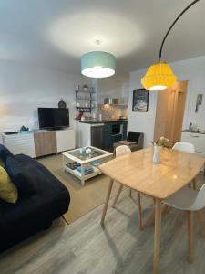 a living room with a table and a dining room at Rance solidor ter in Saint Malo
