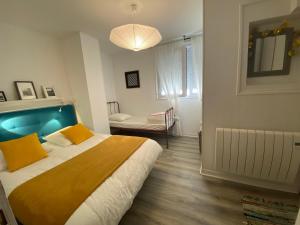 a bedroom with a large bed with a blue headboard at Rance solidor ter in Saint Malo