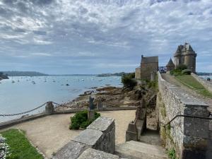 an old castle on the shore of a body of water at Rance solidor ter in Saint Malo