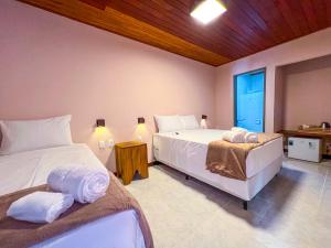 a bedroom with two beds in a room at Pousada Balanço do Mar in Praia do Forte