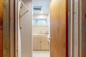 a bathroom with a sink and a toilet and a mirror at Mad River Masterpiece in Irasville +58 photos