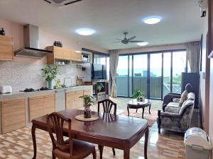 a kitchen and a living room with a table and chairs at Seaview Eagles Nest Apartment 3 in Nai Harn Beach