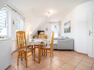 a kitchen and dining room with a table and chairs at Abenteuer Zingst, FW Kormoran 10 in Zingst