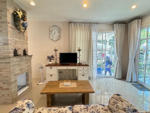 a living room with a table and a fireplace at PY house khaoyai in Khanong Phra +28 photos