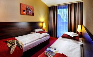 A bed or beds in a room at Wellness Hotel Chopok