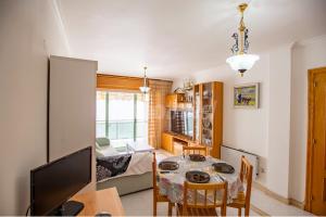 a living room with a table and a dining room at Apartamento a pie de playa in Portonovo