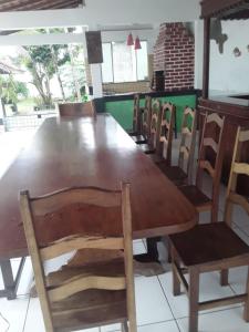a large wooden table and chairs in a restaurant at Casa de Praia para COP 30 in Belém