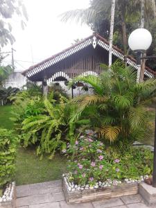 a garden with plants and flowers in front of a building at Casa de Praia para COP 30 in Belém +5 photos