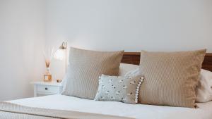 a bedroom with a white bed with pillows at The Piggery in Yarpole