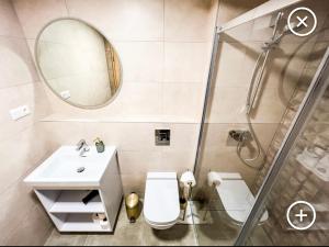 a bathroom with a shower and a toilet and a sink at Apartmán Esprit Y31 in Dolný Kubín +20 photos