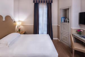 Letto o letti in una camera di Starhotels Terminus