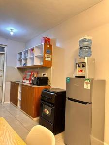 a kitchen with a refrigerator and a counter top at Residence Next Door Coral Mega in Kiambu +6 photos