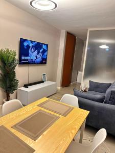 a living room with a table and a couch at Residence Next Door Coral Mega in Kiambu