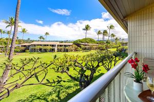 a balcony with a view of a golf course at Napili Shores H263 in Kapalua