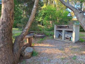 a woodburning stove in a park with a tree at Estrella de mar in Ostende