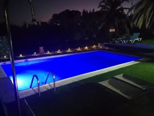 a swimming pool lit up at night at Villa Tranquilla in Estepona