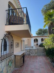 a house with a staircase and a balcony at Casa del Rebaldi in Jávea