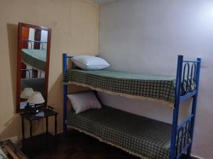 a room with two bunk beds and a mirror at Cordoba 334 in Vedia