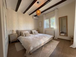 a bedroom with a large bed and a window at Casa del Rebaldi in Jávea +57 photos