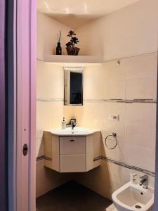 a bathroom with a sink and a toilet at Beautiful three-room apartment in the historic center in Verbania