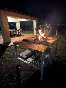a picnic table with a fire on it at night at Antica Vigna Toscana in Poppi +31 photos