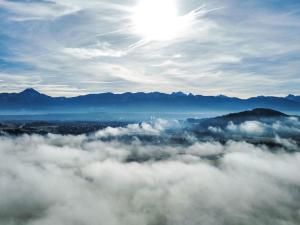 a view of the sun above the clouds at Apartment Frank-2 by Interhome in Feldkirchen in Kärnten