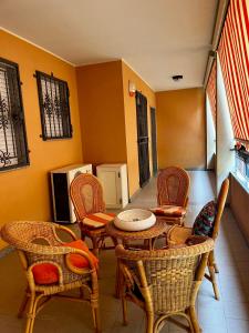 a living room with chairs and a table and chairsktop at La casa di Flora Appartamento ad Alghero in Alghero +9 photos