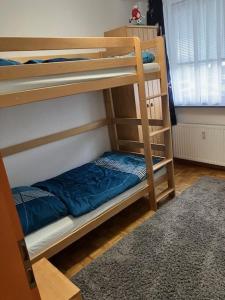 two bunk beds in a room with a rug at LeaID in Idstedt