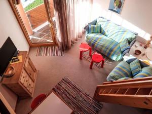 a living room with a couch and a mirror at Apartment Girun by Interhome in Flims
