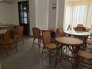 a room with tables and chairs in a room at Magnolia Guest House in St. Julianʼs
