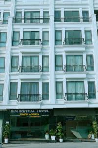 a white building with balconies and a hotel at Kim Sentral Hotel in Ha Long