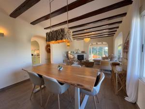 a dining room with a wooden table and chairs at Casa del Rebaldi in Jávea