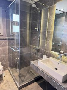 a bathroom with a sink and a glass shower at The Pyramid Escape in Cairo +6 photos
