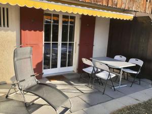 a table and chairs sitting outside of a house at Apartment Oberland Nr- 29 by Interhome in Gstaad