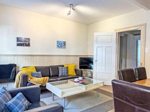 a living room with a couch and a table at Apartment Haus Gertsch Apt-G by Interhome in Wengen +20 photos