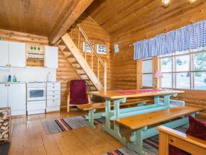 a dining room with a table in a log cabin at Holiday Home Eteläranta by Interhome in Hara