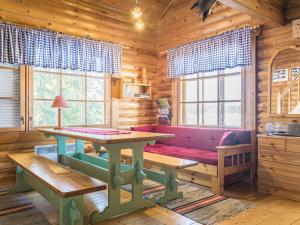 a living room with a couch and a table in a log cabin at Holiday Home Eteläranta by Interhome in Hara