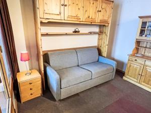 a couch in a room with a bunk bed at Apartment Eskival 106 by Interhome in Val Thorens